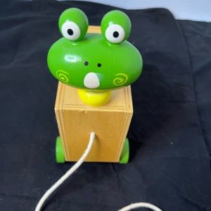 Wooden frog Coin bank with wheels and string to pull alone.
